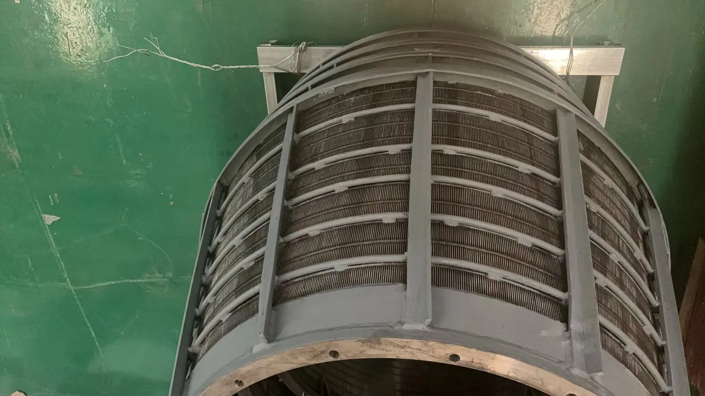 Close-up of a wedge-wire screen centrifuge basket showing the precision slot openings that drain moisture while retaining coal solids